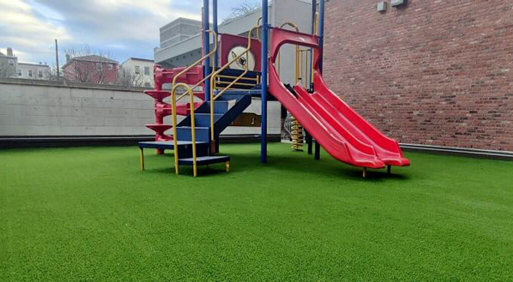 Artificial turf playground safety surface