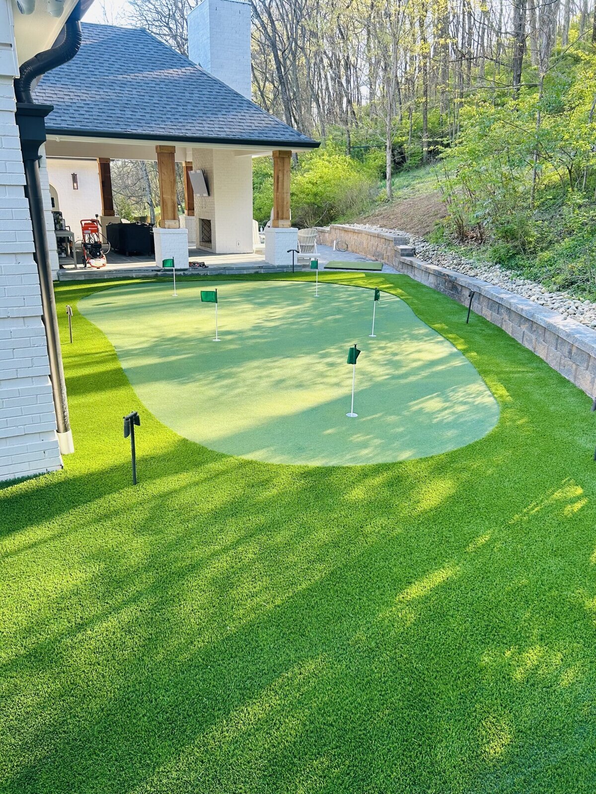 Backyard Lawn and Putting Green Off Outdoor Kitchen