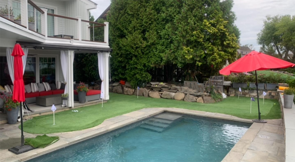 Backyard putting green around pool