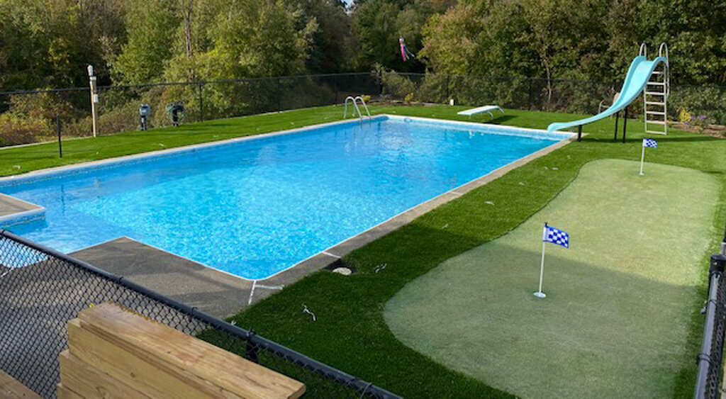 Backyard putting green and turf around pool