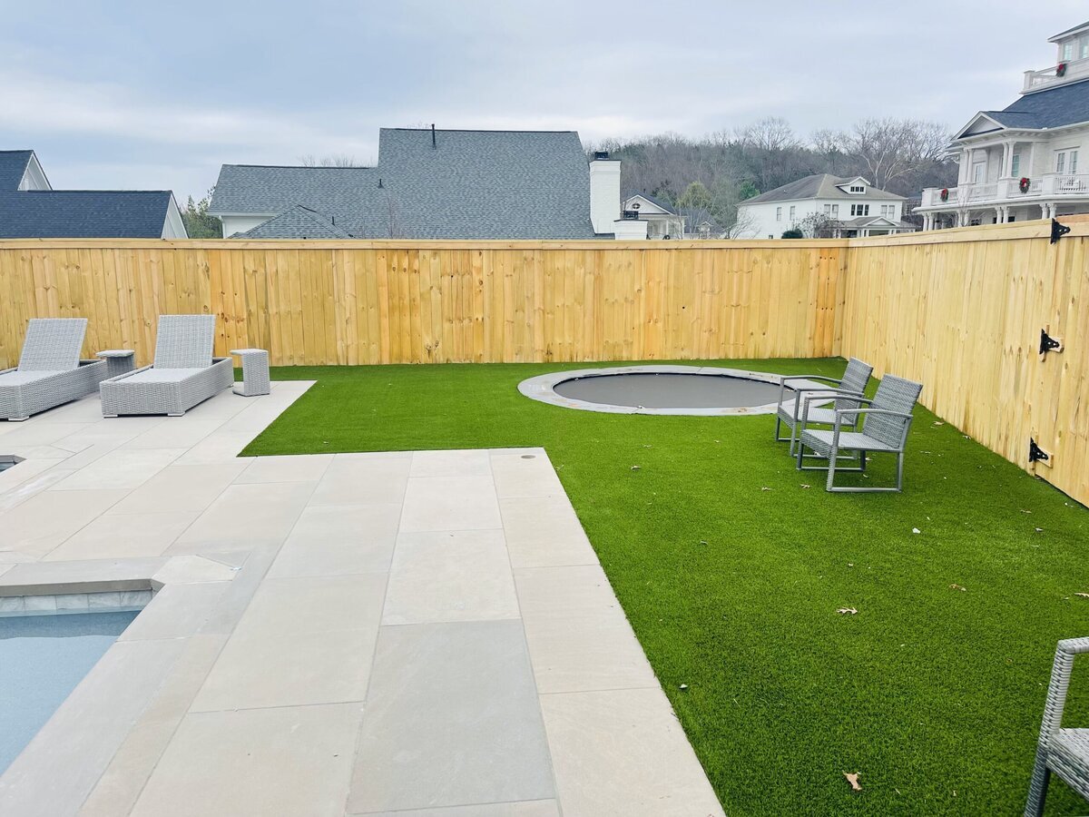 Sunken Trampoline Next to Pool with Artificial Turf