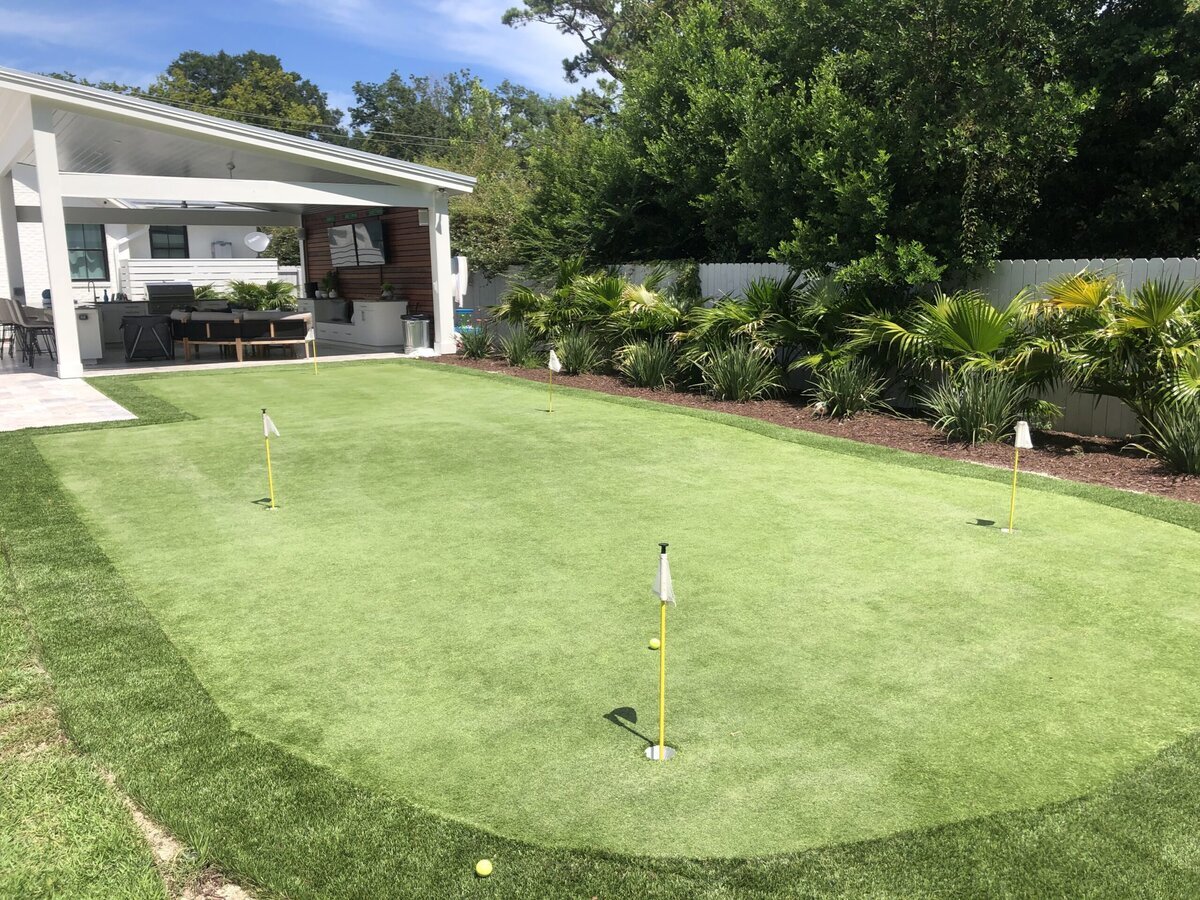 Undulating Backyard Putting Green with Fringe Off Outdoor Kitchen