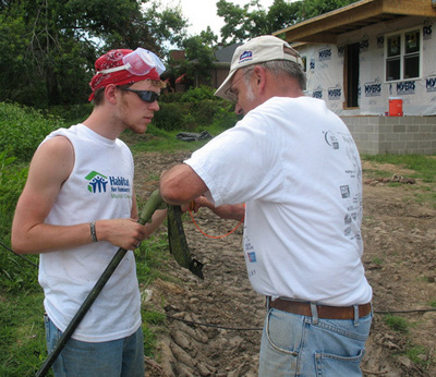 St. John's parishioner and All Saints' summer camp counselor work together on Habitat house in Mayfield