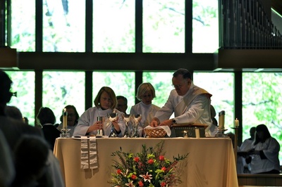 Newly ordained deacons set the table during Eucharist