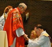 Bishop Ted Gulick presents a Bible to ordinand Ed Lane