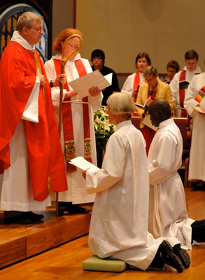 Bishop Ted Gulick, assisted by Canon Joan Smith, as Suzanne Warner and Daniel Kuol kneel