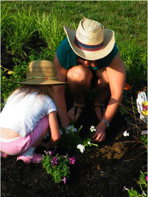 Gardeners plant petunias during VBS