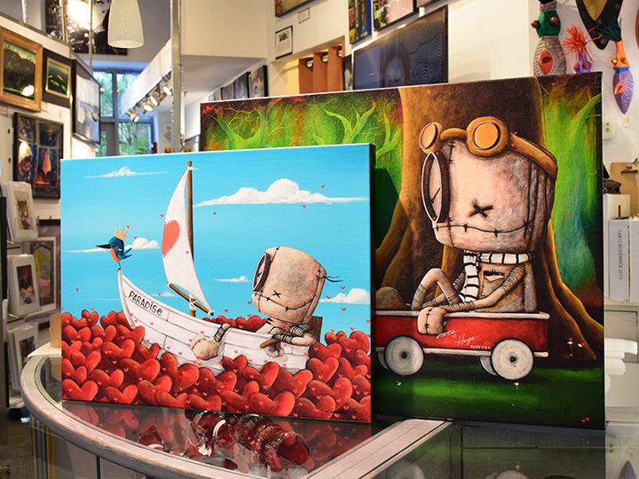 Two canvas art pieces by Dianne Romer Nomiie on display at Pop Gallery