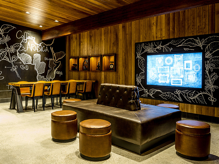 The interior of Starbucks at Disney Springs West Side featuring communal seating and chalkboard design elements