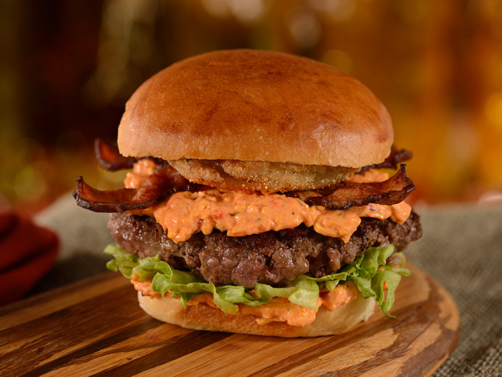 The D Luxe Southern Burger topped with fried green tomatoes, pimento cheese, lettuce and bacon