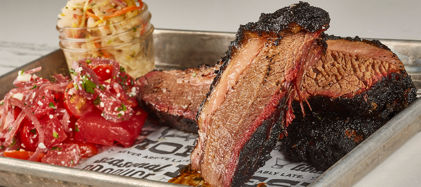 A tray of brisket, tomatoes and slaw from The Polite Pig at Disney Springs