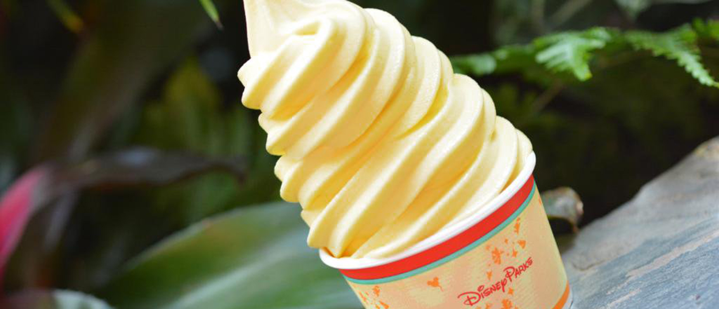 A tall swirl of soft serve Dole whip in a Disney Parks cup