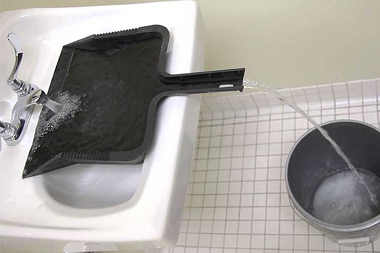 Use A Dust Pan To Fill A Bucket From The Sink
