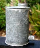 Figure 1: Replica of a metal grain silo. Grain is added to the silo through an opening at the top (normally kept sealed). Grain is accessed through the spout at the bottom.