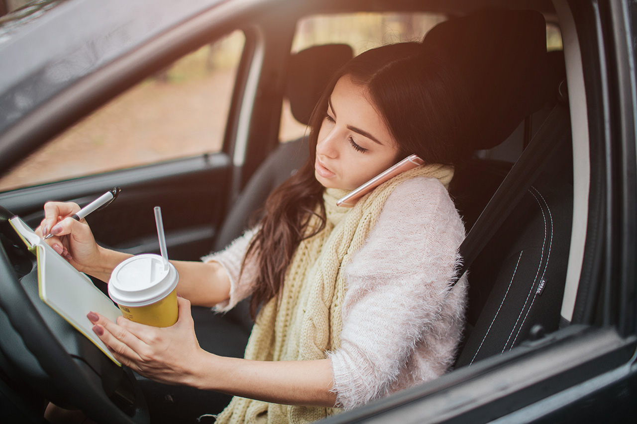 Person driving distracted, one of the leading causes of car accidents