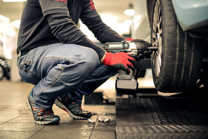 Mechanic performing wheel repair