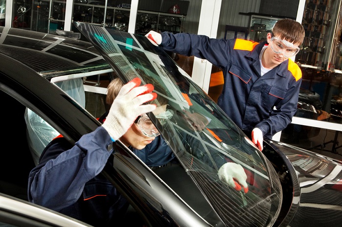 Men performing windshield repair and replacement