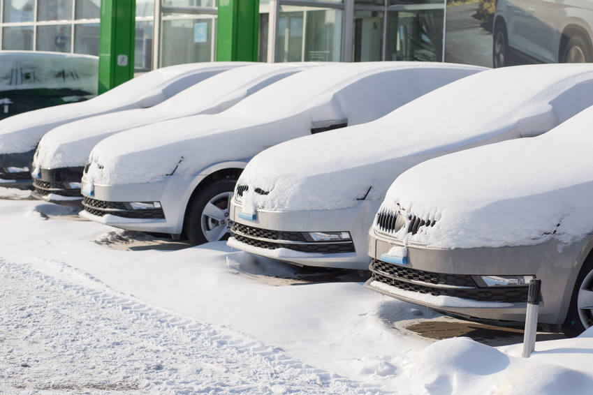Parked cars in winter needing car body maintenance