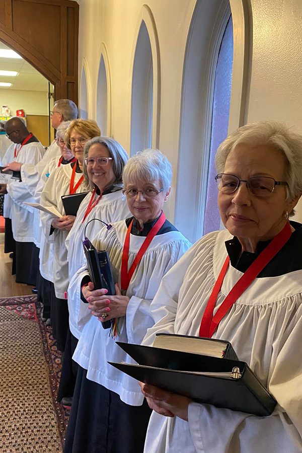 Members of the Saint John's choir lined up in their robes before the service