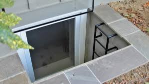 This is a picture of a basement egress window with a ladder