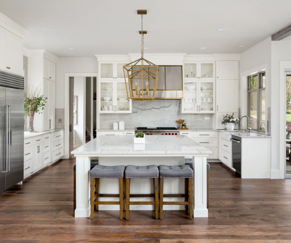 A modern kitchen featuring custom cabinets and quartz countertops from Freedom Flooring Interiors.