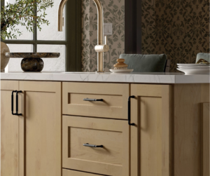 A modern kitchen featuring custom cabinets and quartz countertops from Freedom Flooring Interiors.