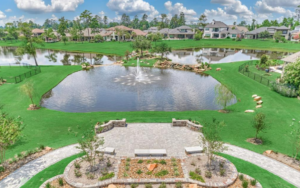 A landscaped community park centered around a serene pond with a fountain at Auburn Lakes in Spring Texas