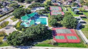 Steeplechase community recreation area featuring a clubhouse, large swimming pool, and multiple tennis courts.