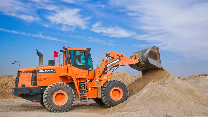 Orange excavator at a construction site.