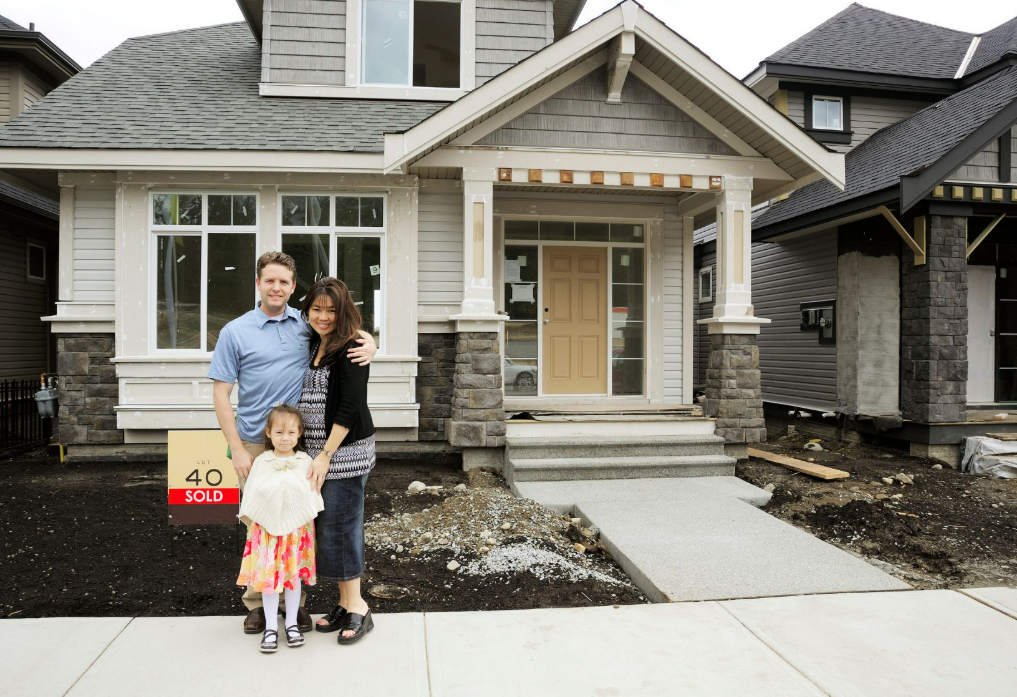 Happy family with a new house