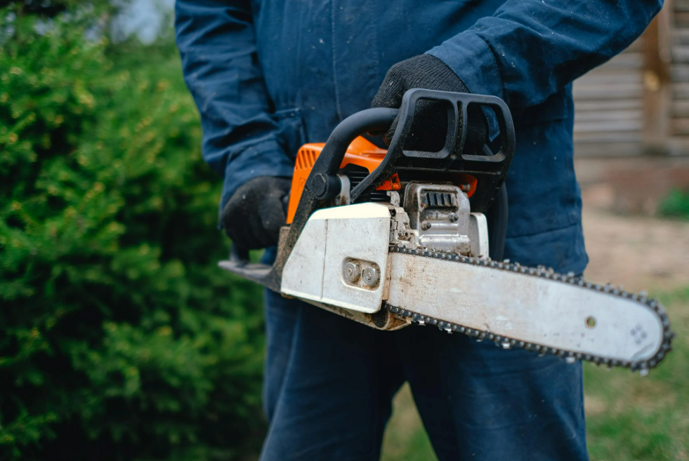 A Person Holding a Chainsaw