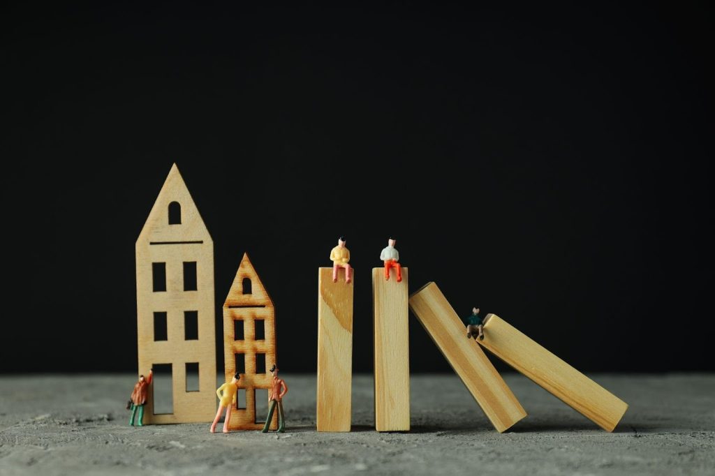 small wooden blocks shaped like houses and bars, with tiny people figures around them