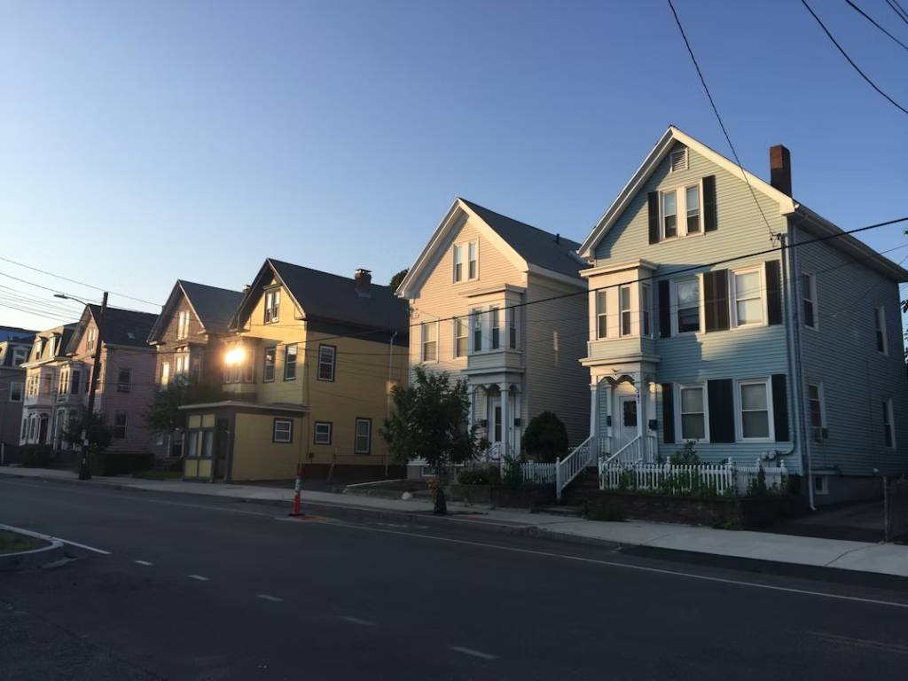 two-story houses lines a quiet street at sunset