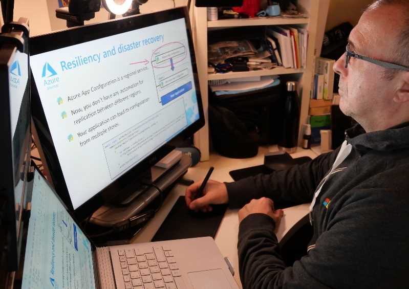 Azure Technical Trainer Massimo Bonanni drawing on a slide using a graphics tablet, while presenting on camera.