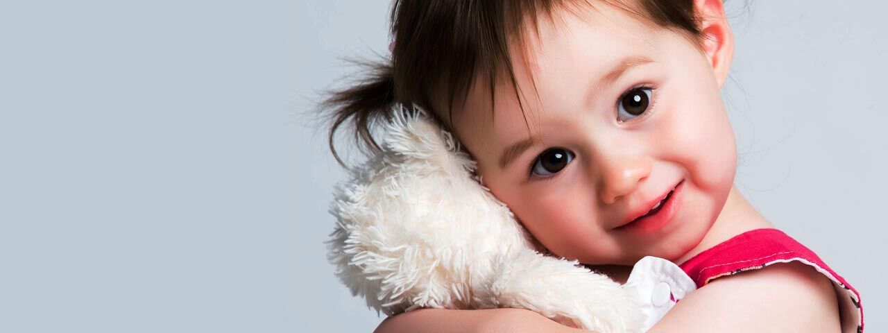 Little girl hugging a stuffed animal in Kissimmee, Florida