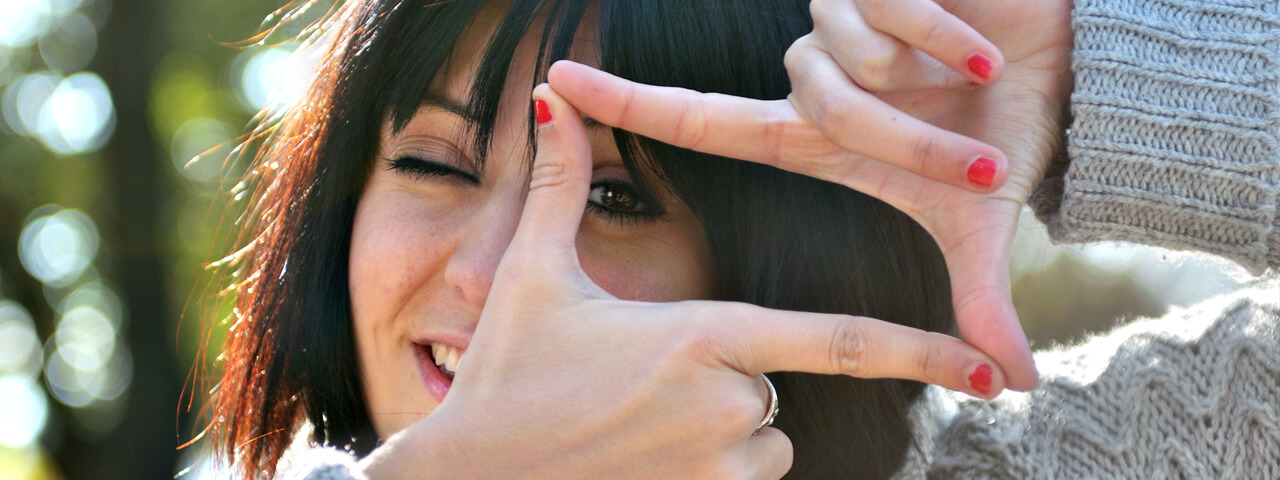 Woman pretending to look through photo lens
