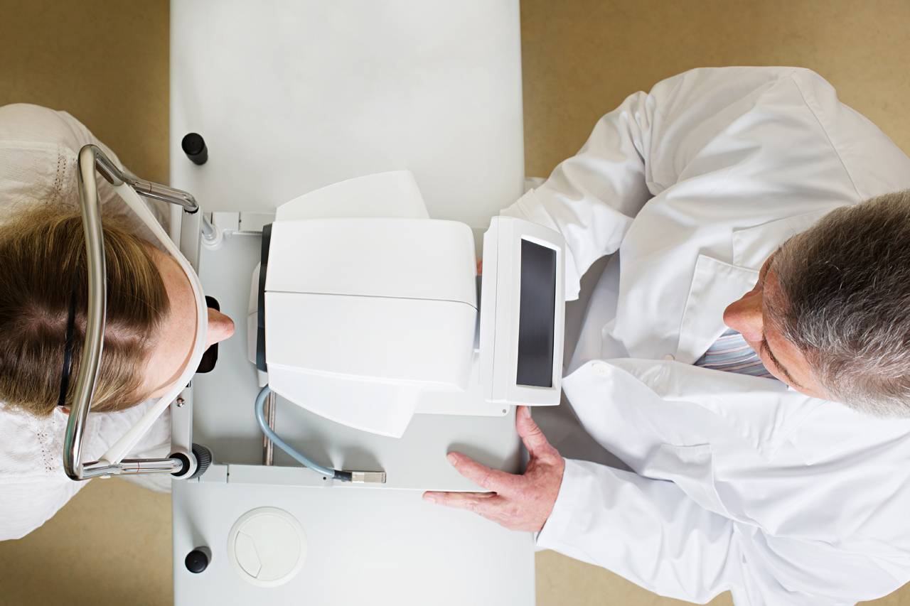 Optometrist, man receiving eye exam in Raleigh, NC