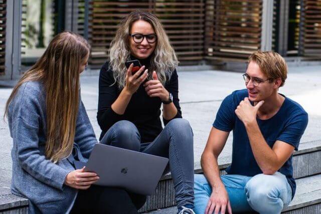 people with eyeglasses using computer and smartphone to leave 5-star reviews of Executive Eye Care
