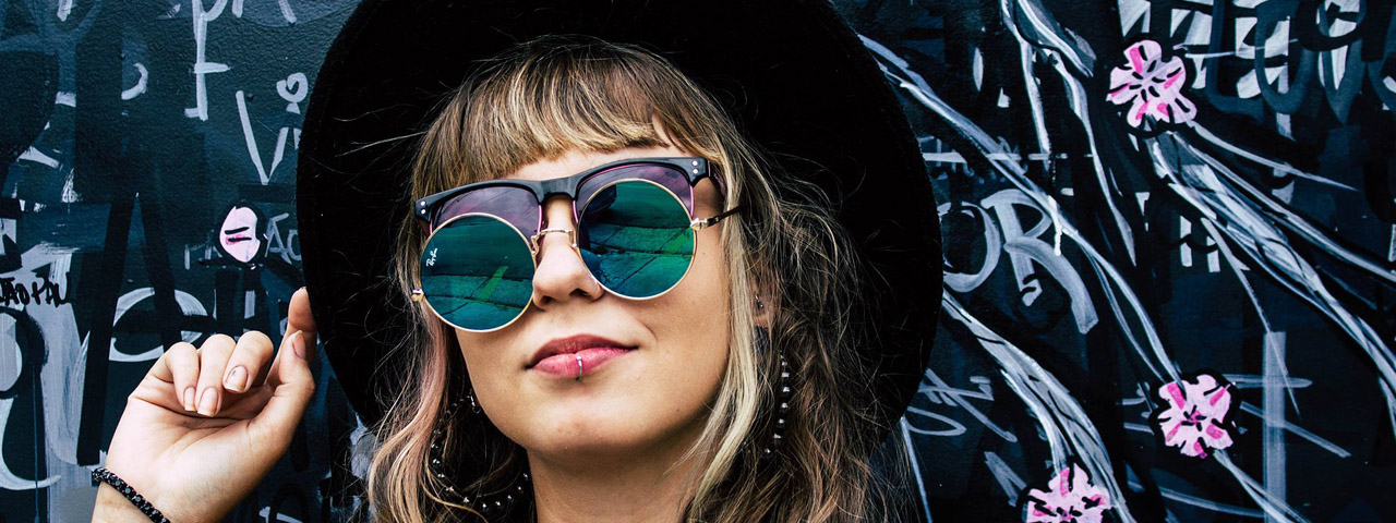Girl wearing two pairs of sunglasses