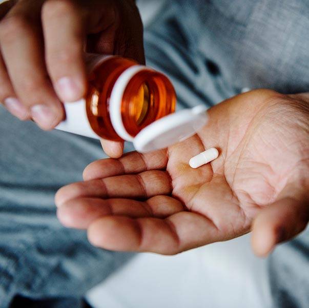 Man taking nutritional supplements