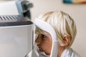 Boy with chin on machine