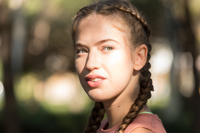 Optometrist, girl standing in light with transition contact lens in Longview, TX