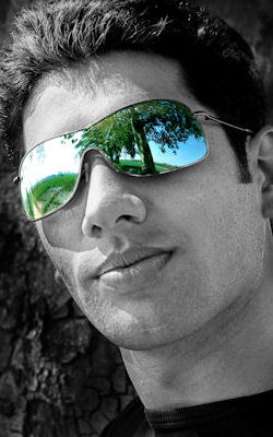 man with reflection in glasses