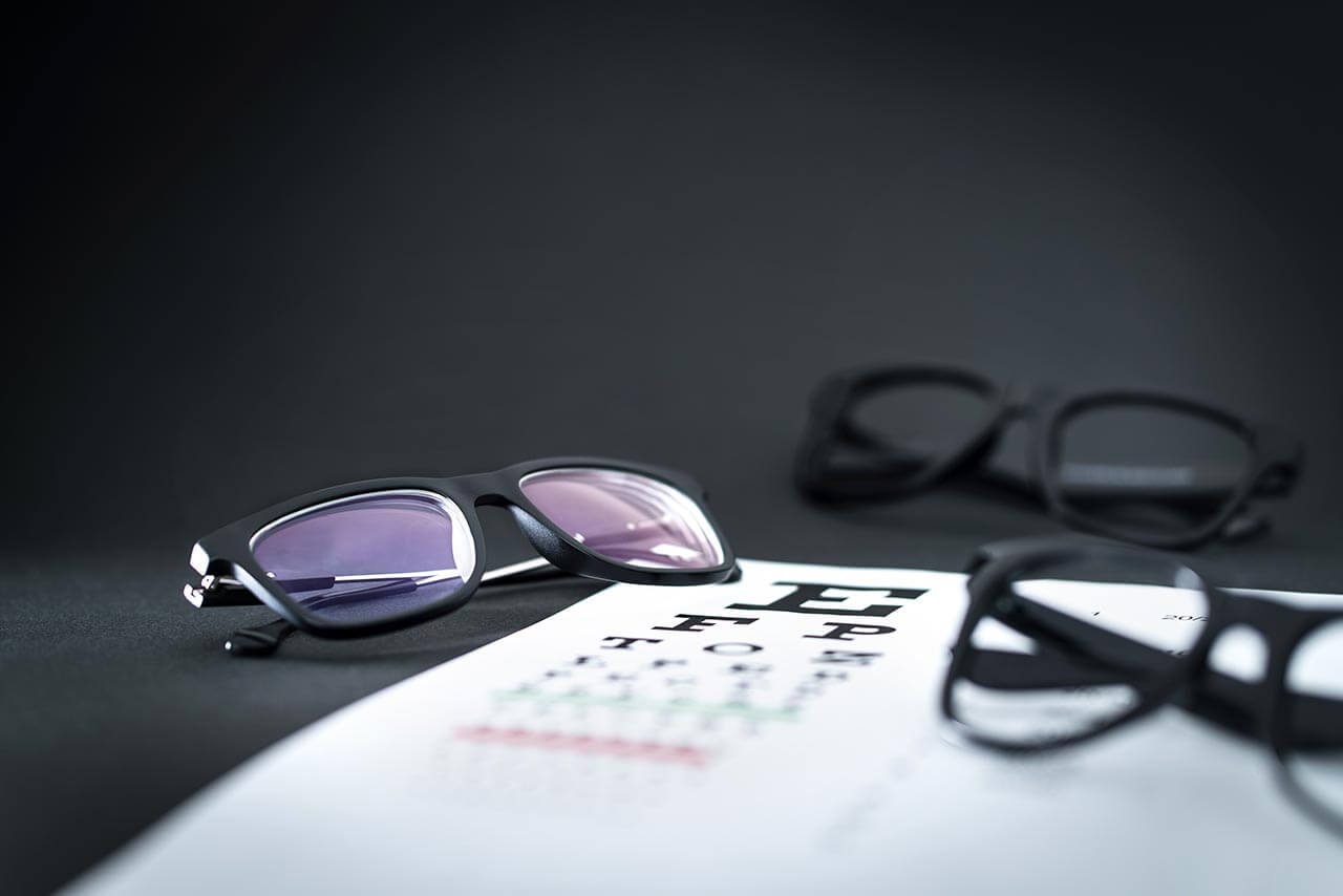 eyeglasses on top of eye chart