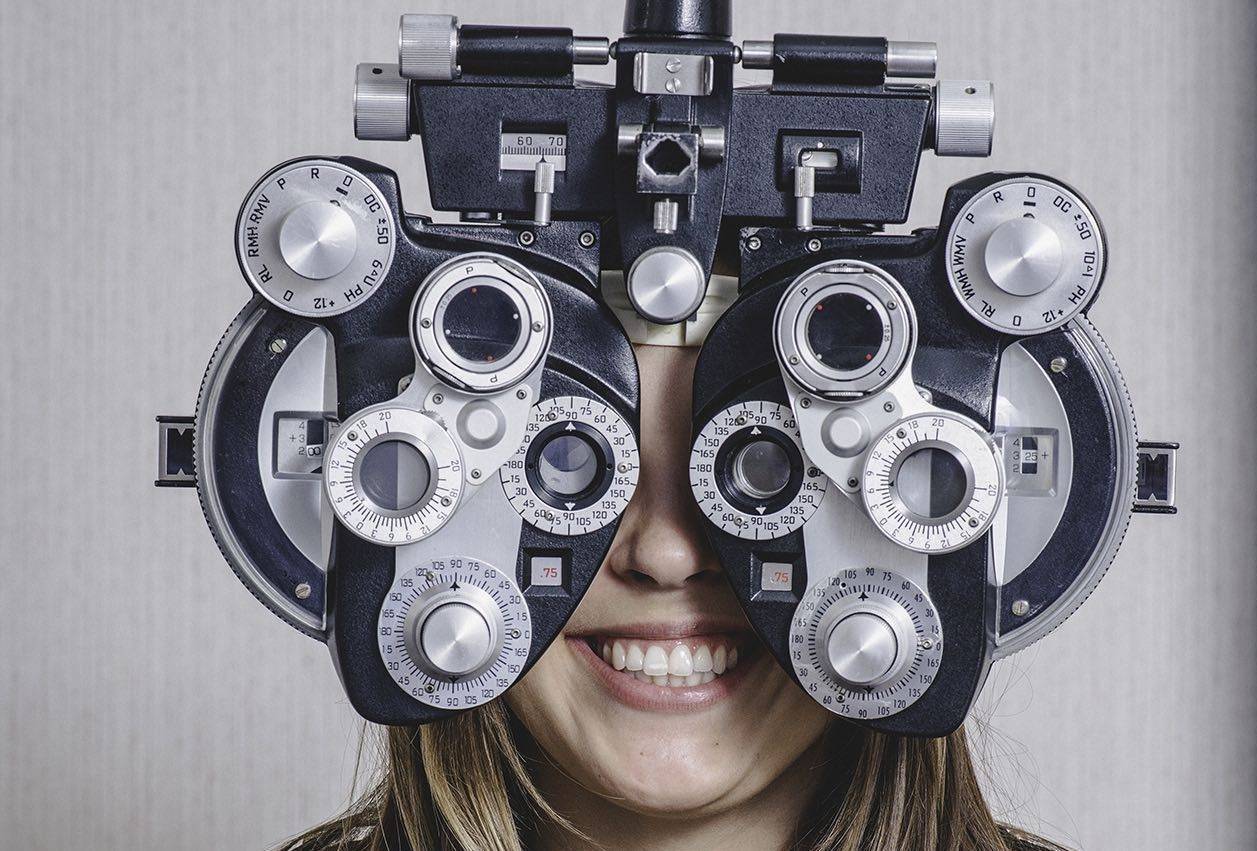 optician holding eyeglasses