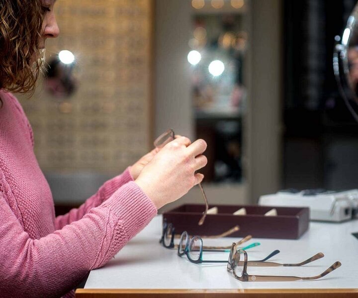 optician holding eyeglasses