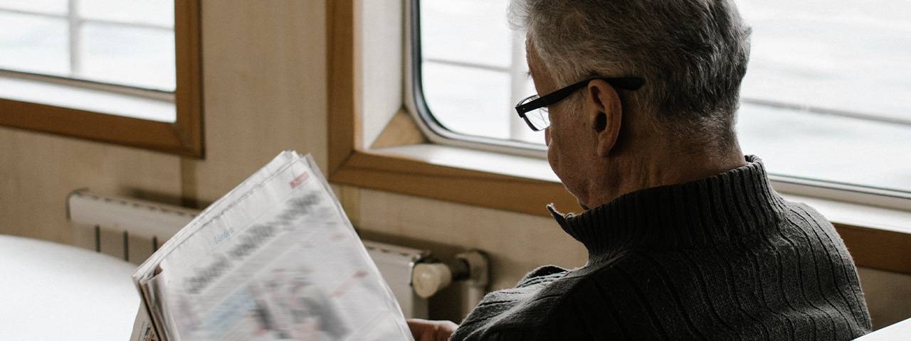 senior man reading newspaper