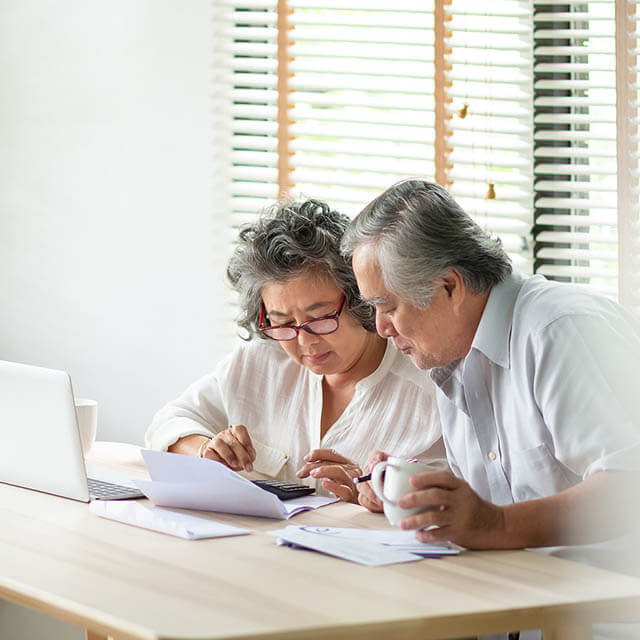 Stressed Asian Senior Couple Using Calculator And Calculate Fami