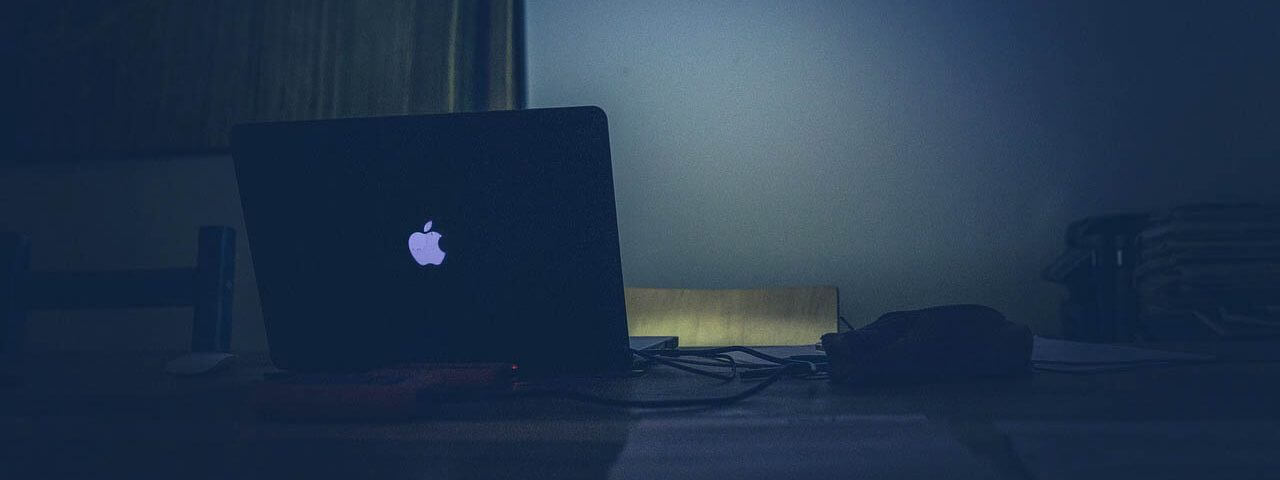 Open laptop, emitting blue light
