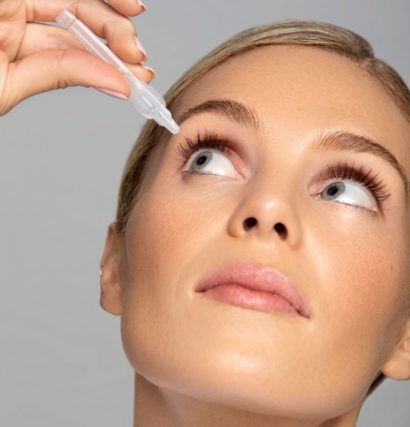 woman putting on an eye drop